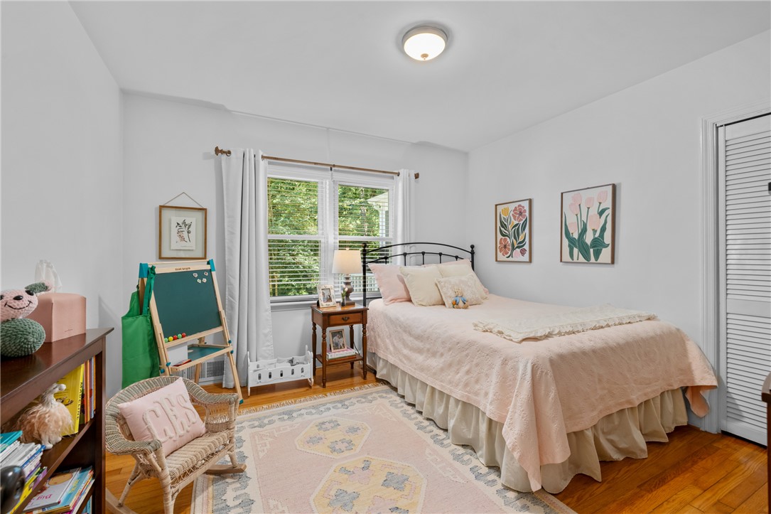 203 Augusta Road Clemson, SC 29631 - Photo 17 of 31 Warm hardwood floors and a wide window frame a cozy bedroom retreat.