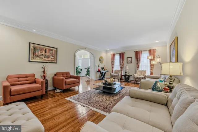 a living room with patio furniture and a potted plant