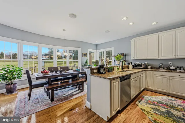 a view of a hallway with wooden floor and stairs