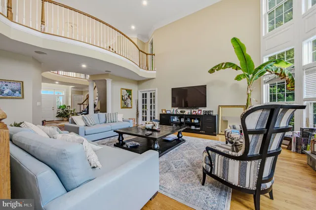 a view of a white house with a big yard and large trees