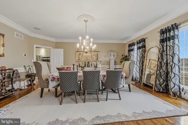 a living room with furniture floor to ceiling window and potted plant