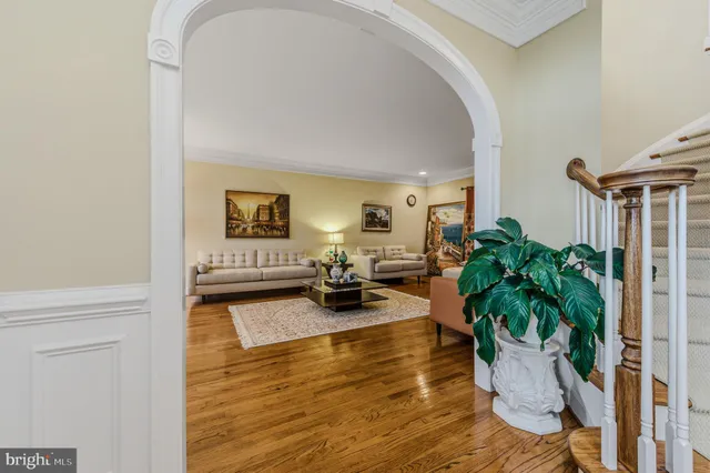 a dining room with furniture a chandelier and wooden floor