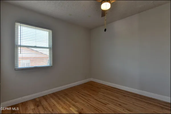 a view of a room with wooden floor and windows