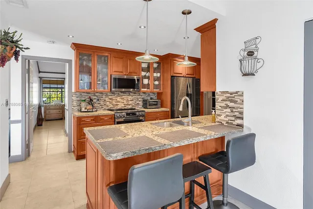 a kitchen with stainless steel appliances granite countertop a stove and a refrigerator