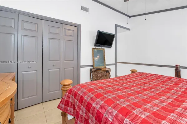 a bedroom with a bed and a television