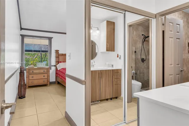 a en suite bathroom with a tub mirror and shower