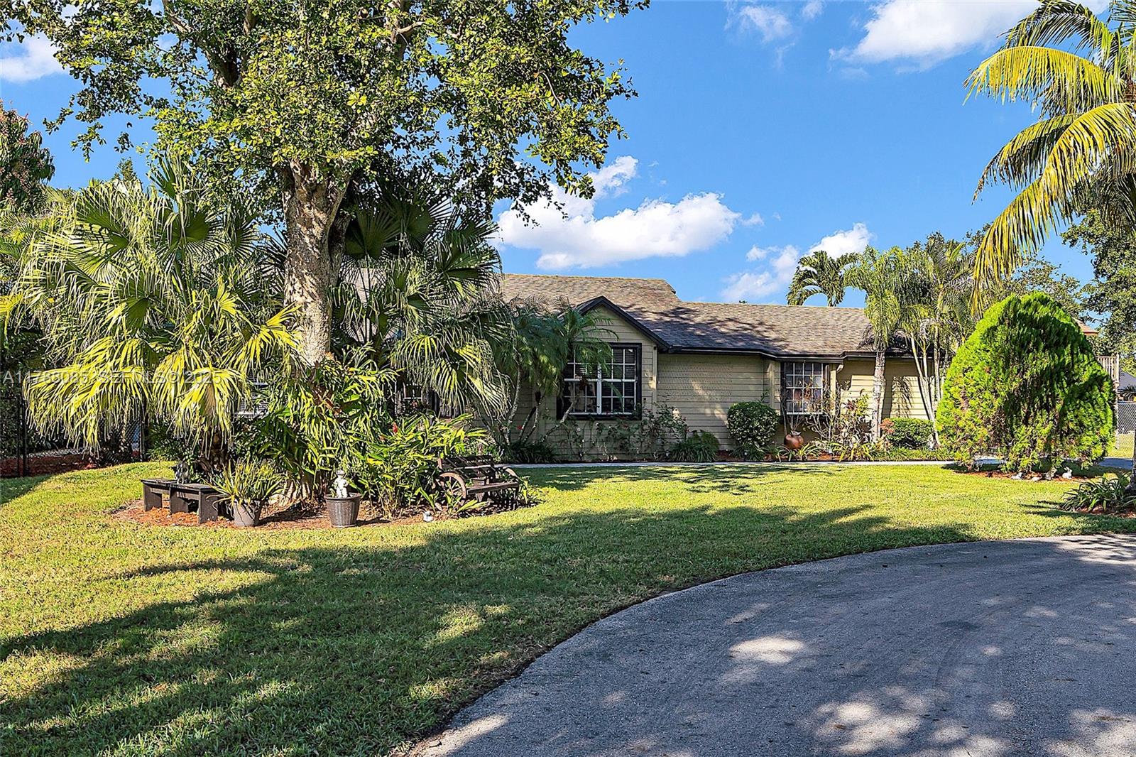 15031 Southwest 154th Terrace Miami, FL 33187 - Photo 37 of 40 a front view of a house with a yard and garage