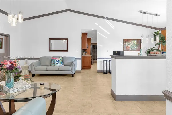 a living room with furniture and flowers