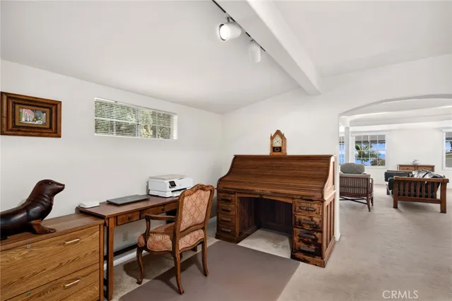 a living room with furniture and a piano