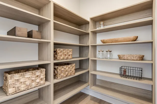 a view of walk in closet with clothes and shoes