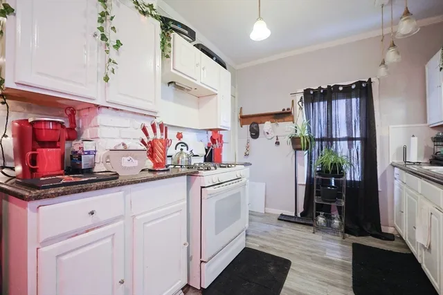 a kitchen with granite countertop a sink stainless steel appliances and cabinets