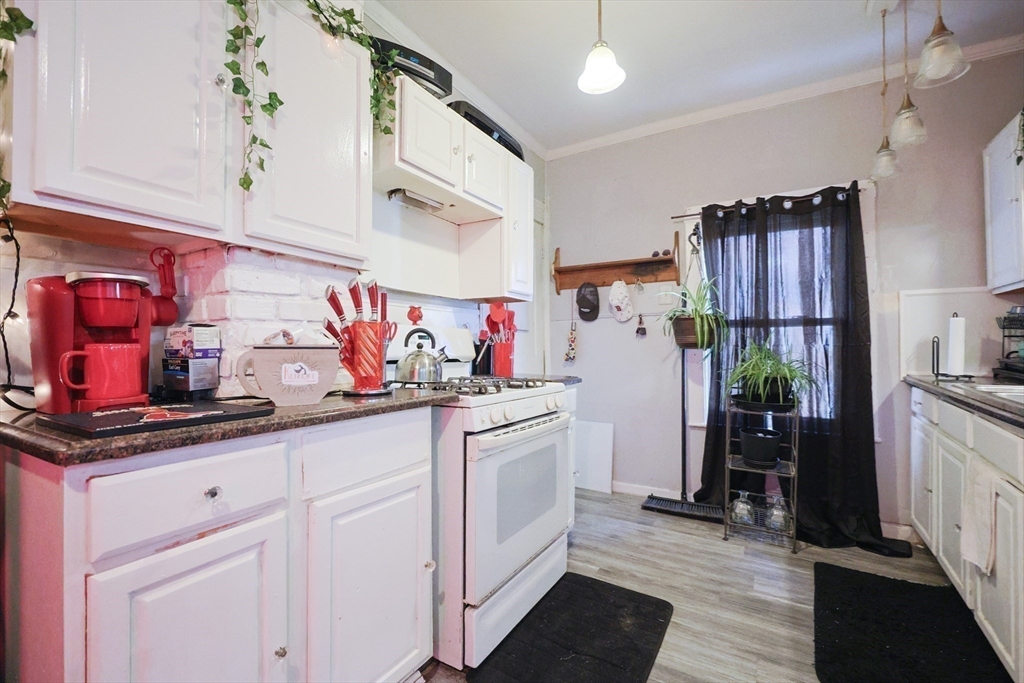 230 Pleasant Street Worcester, MA 01609 - Photo 15 of 23 a kitchen with granite countertop a sink stainless steel appliances and cabinets