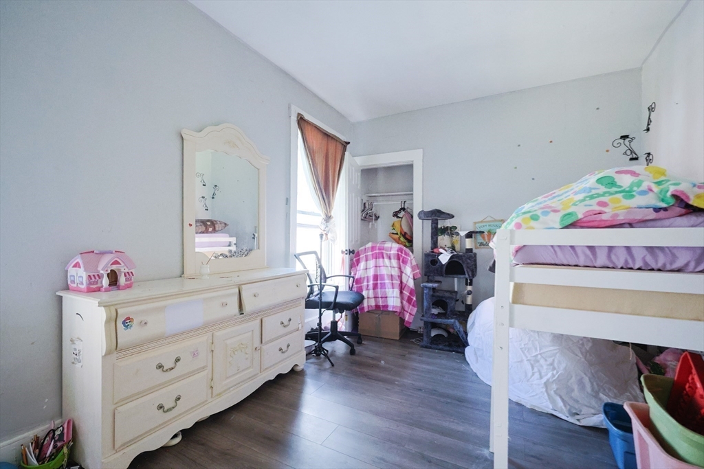 230 Pleasant Street Worcester, MA 01609 - Photo 17 of 23 a bedroom with a bed and wooden floor