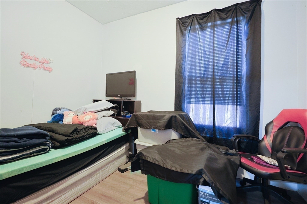 230 Pleasant Street Worcester, MA 01609 - Photo 18 of 23 a bedroom with furniture and a chair