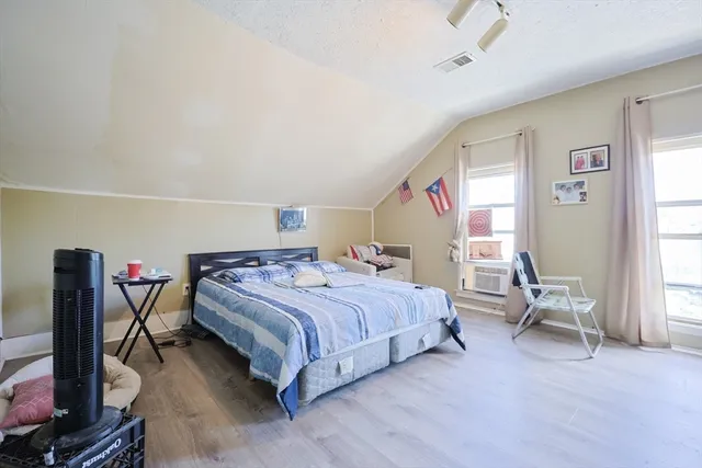 a bedroom with a bed and a table