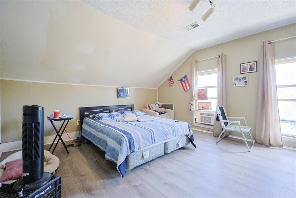 230 Pleasant Street Worcester, MA 01609 - Photo 20 of 23 a bedroom with a bed and a table