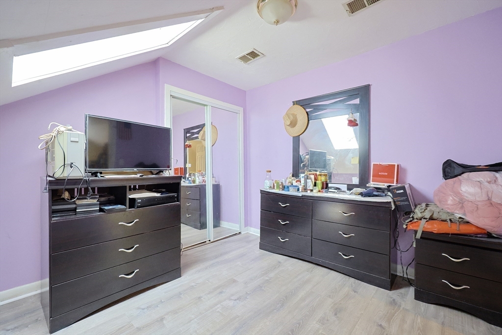 230 Pleasant Street Worcester, MA 01609 - Photo 21 of 23 a room with a bed and flat screen tv