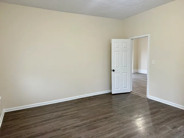 an empty room with wooden floor