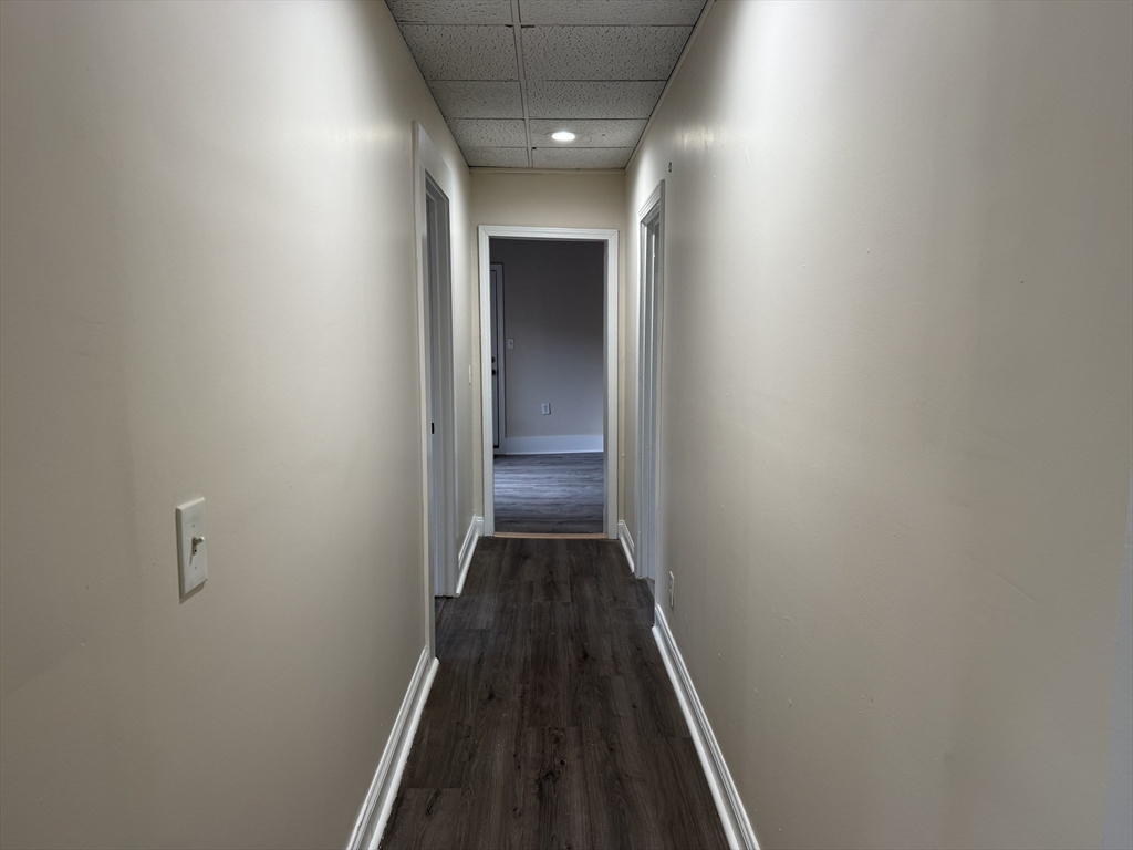 230 Pleasant Street Worcester, MA 01609 - Photo 8 of 23 a view of a hallway with wooden floor and staircase