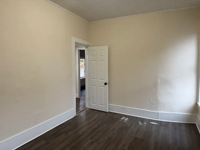 a view of an empty room and wooden floor