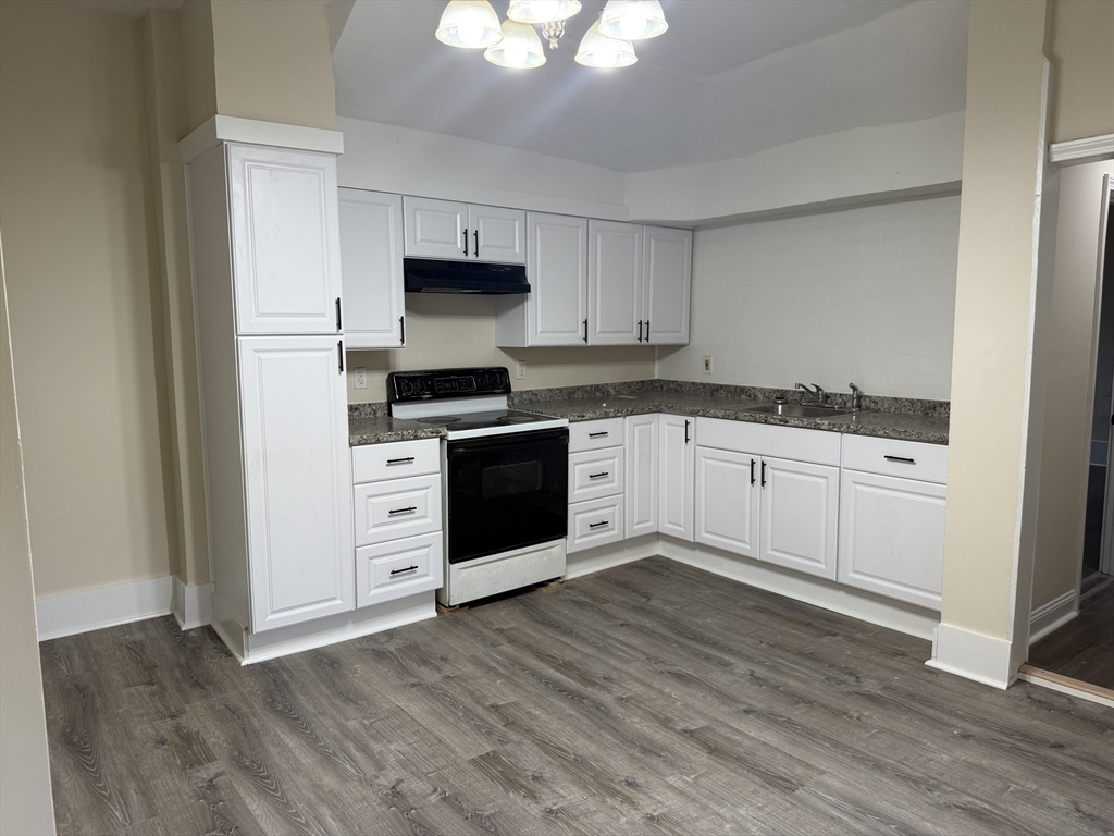 230 Pleasant Street Worcester, MA 01609 - Photo 10 of 23 a kitchen with granite countertop a sink cabinets and stainless steel appliances