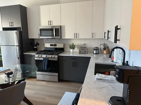 a kitchen with a sink a stove and refrigerator