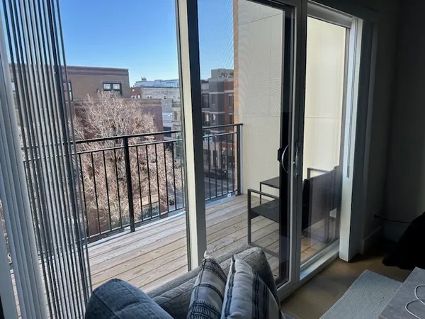 a view of a balcony with a floor to ceiling window