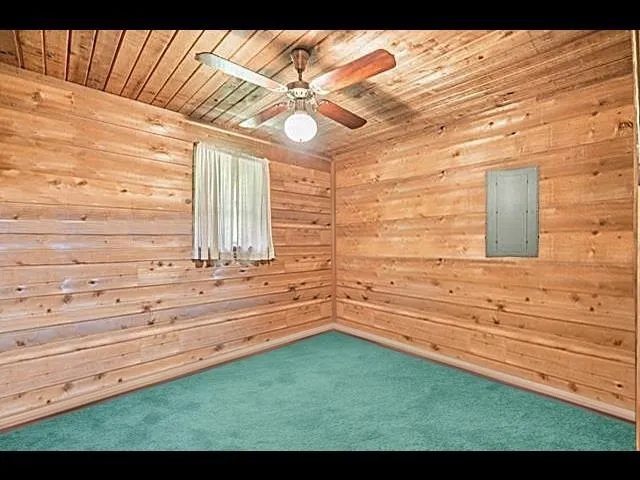 an aerial view of residential house with outdoor space and trees all around