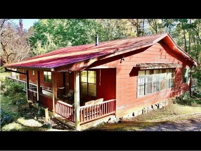 a view of a house with backyard and porch