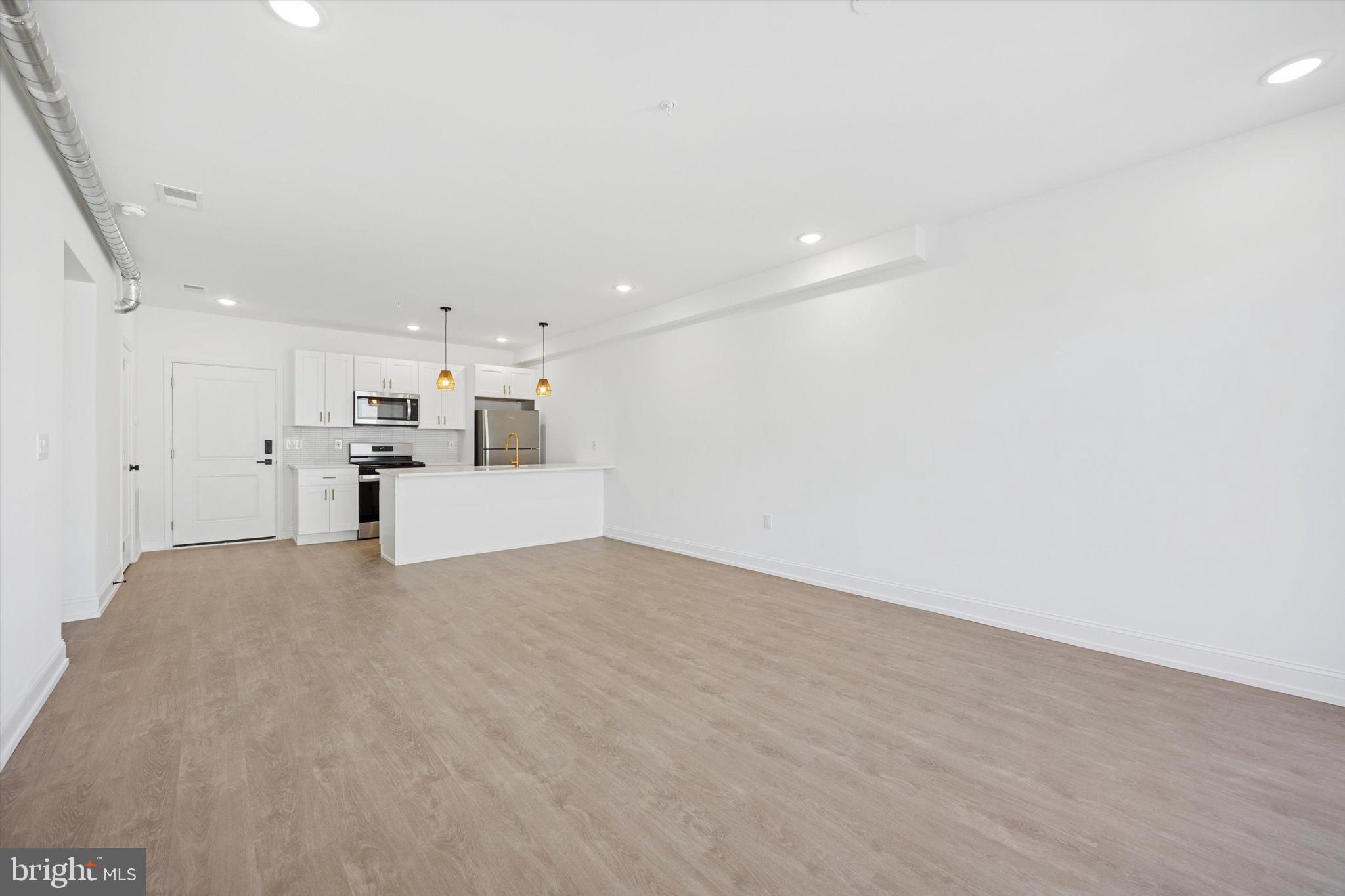 a view of a big room with closet and windows