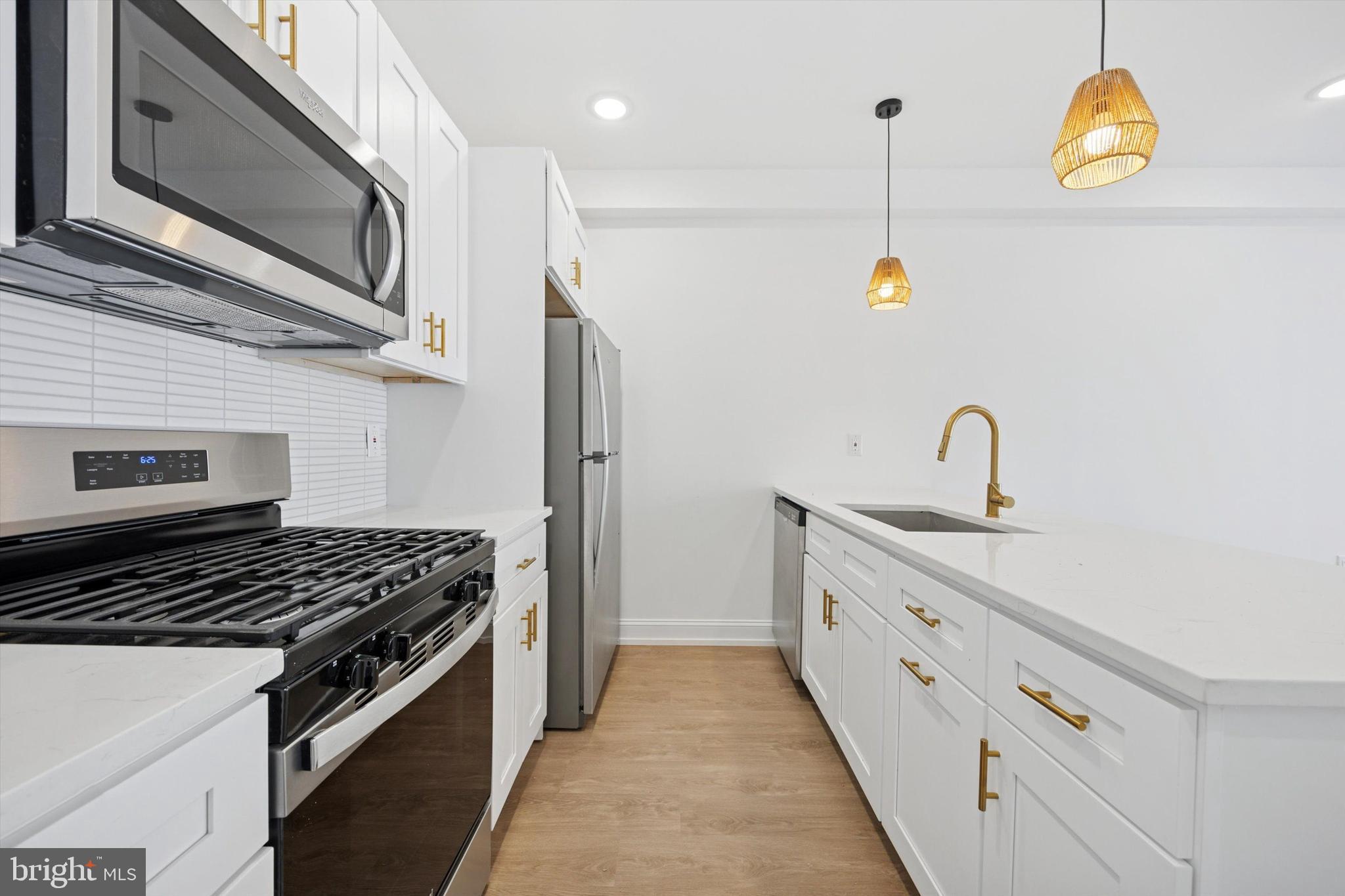 1614 Ridge Avenue, Unit 504 Philadelphia, PA 19130 - Photo 3 of 10 a kitchen with stainless steel appliances granite countertop a sink and a stove