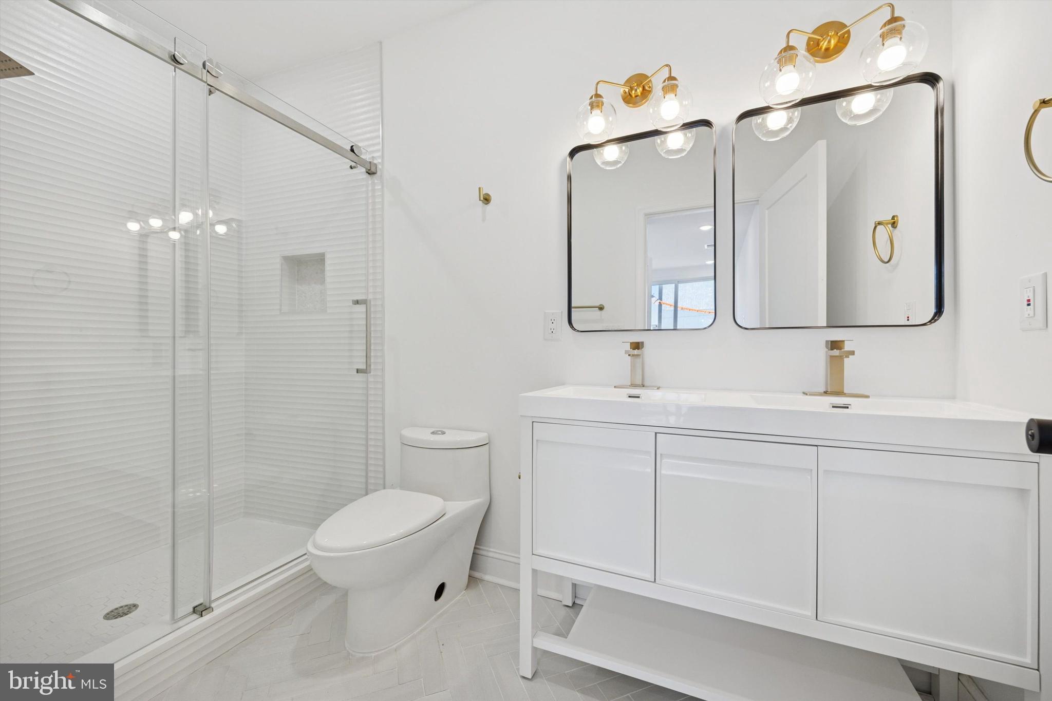 1614 Ridge Avenue, Unit 504 Philadelphia, PA 19130 - Photo 10 of 10 a bathroom with a toilet sink and mirror