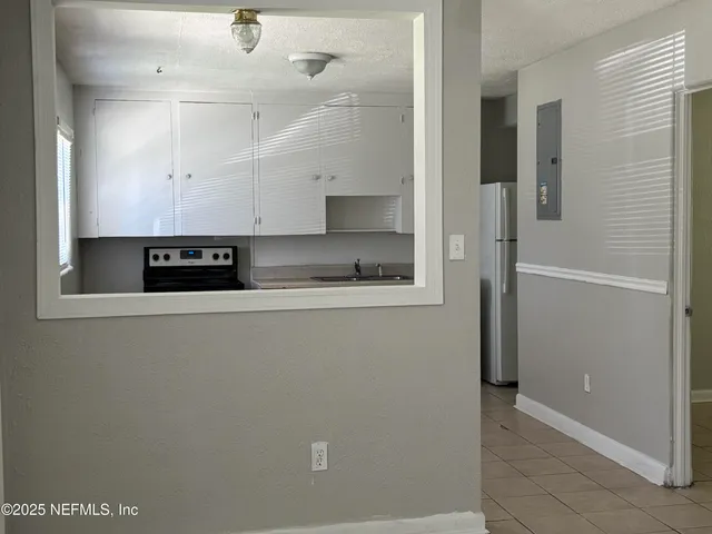 a view of kitchen with stainless steel appliances granite countertop cabinets and a refrigerator