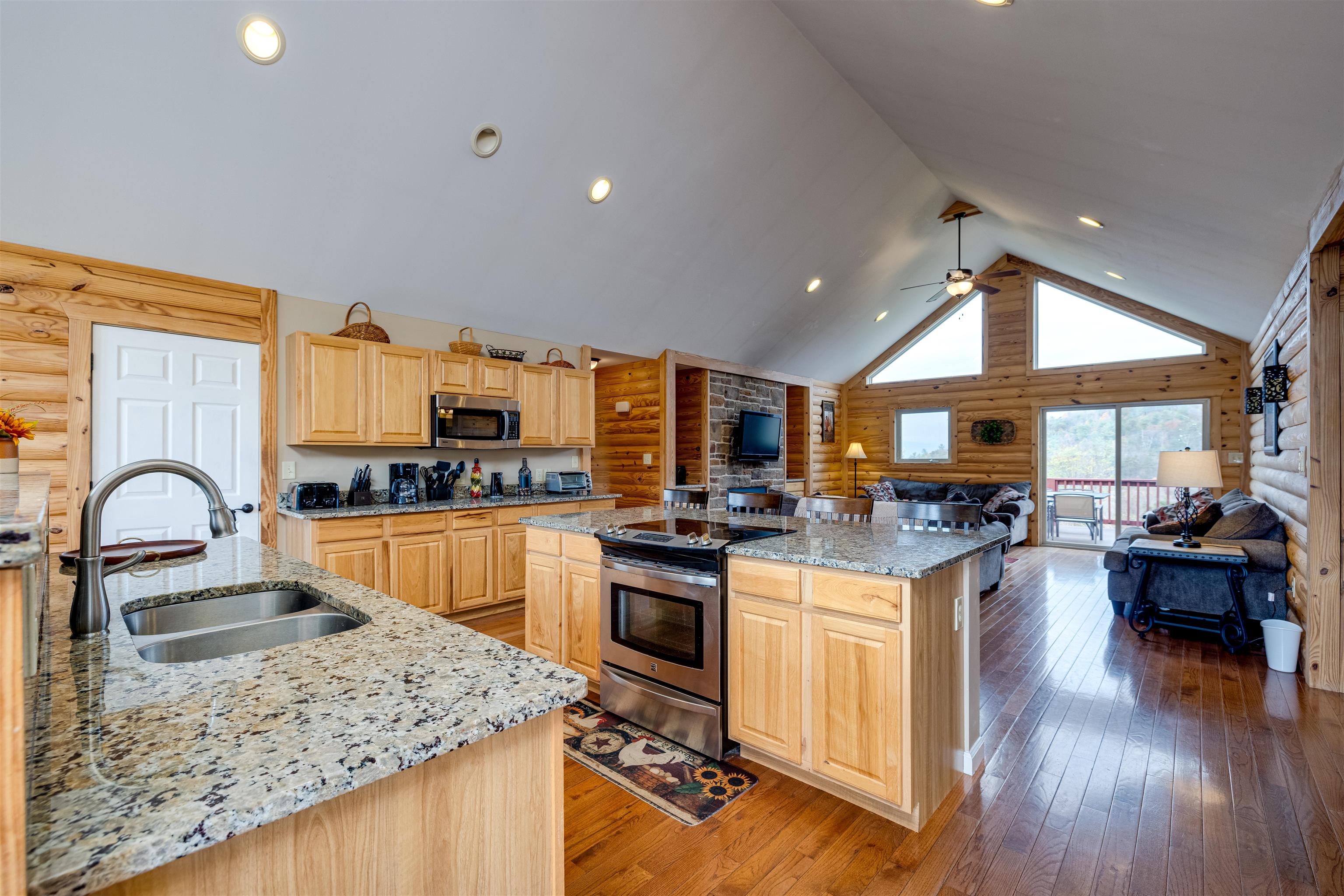 2225-2319 Valley Burg Road Luray, VA 22835 - Photo 12 of 57 a kitchen with a stove a sink dishwasher a dining table and chairs with wooden floor
