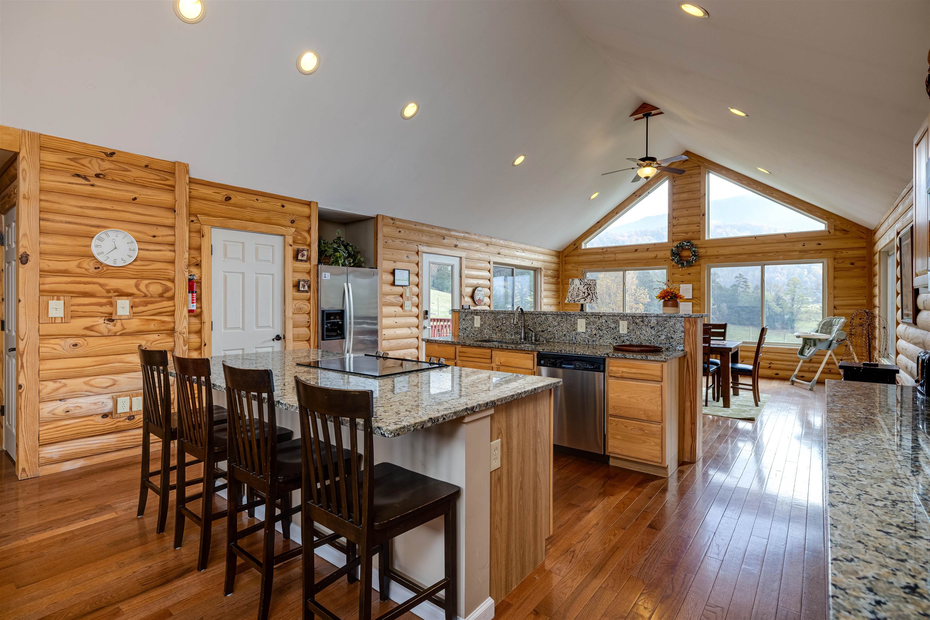 2225-2319 Valley Burg Road Luray, VA 22835 - Photo 9 of 57 a kitchen with stainless steel appliances kitchen island granite countertop a table chairs and a stove