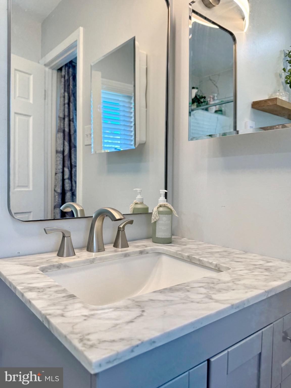 7406 Robin Road La Plata, MD 20646 - Photo 52 of 89 Sleek marble vanity in a modern bathroom.