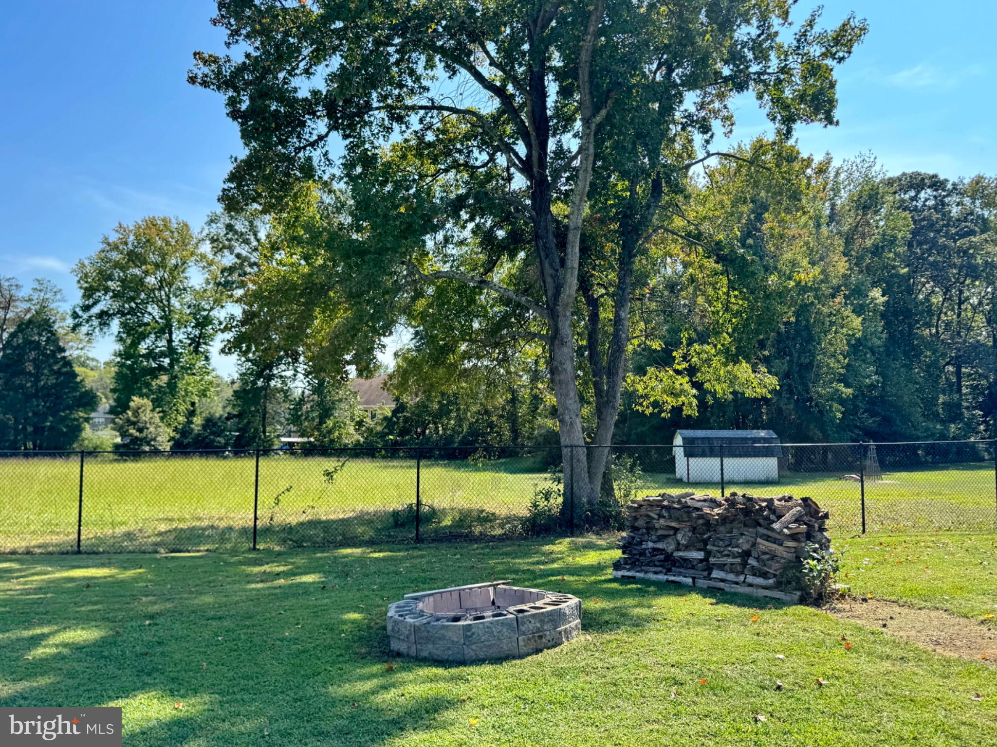 7406 Robin Road La Plata, MD 20646 - Photo 77 of 89 Serene backyard with fire pit and trees.