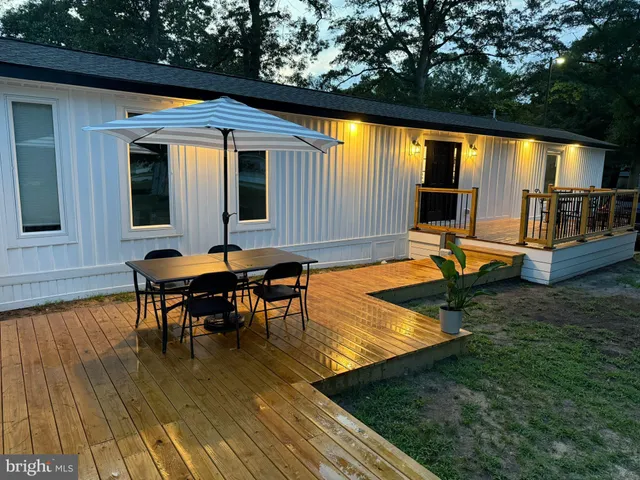 a backyard of a house with table and chairs
