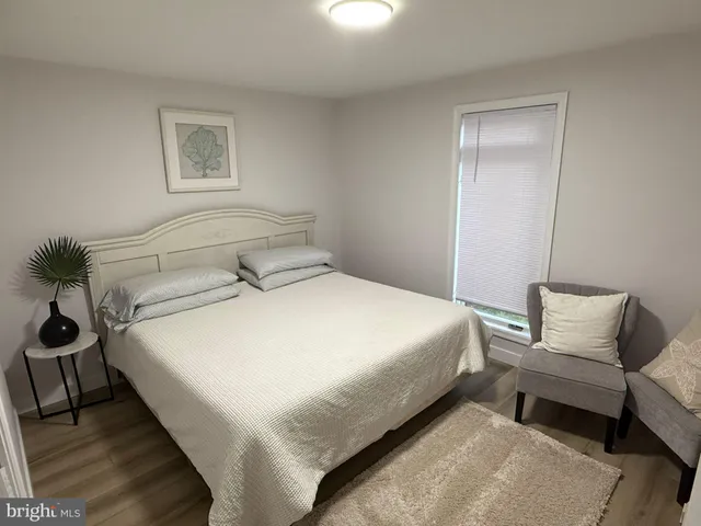 a bedroom with a bed and a chair