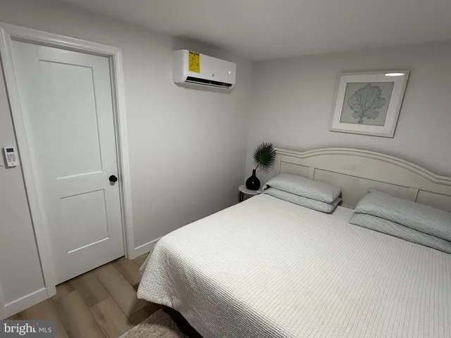 a bedroom with a bed and a wall painting