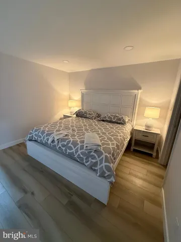 a bedroom with a bed and a night stand