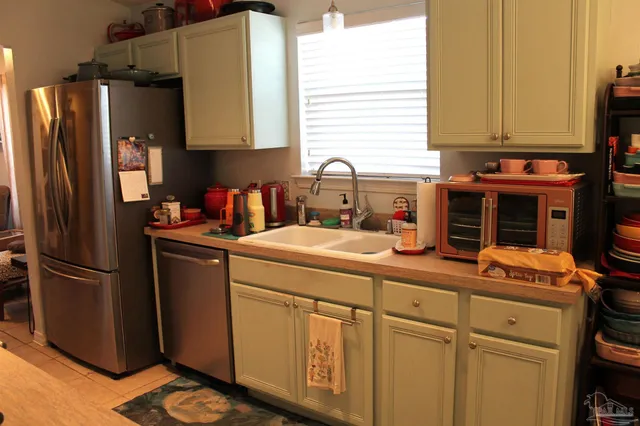 a kitchen with stainless steel appliances granite countertop a refrigerator and a stove