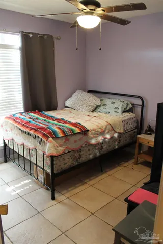 a bedroom with a bed and a mirror