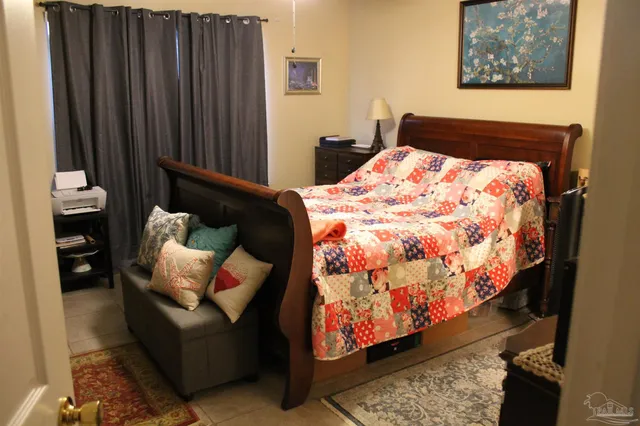 a bed sitting in a bedroom next to a window