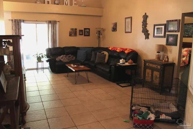a living room with furniture and a floor to ceiling window