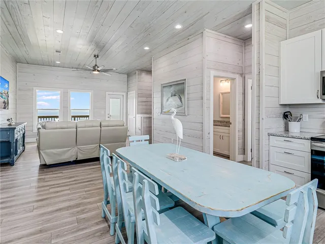 a kitchen with cabinets and wooden floors