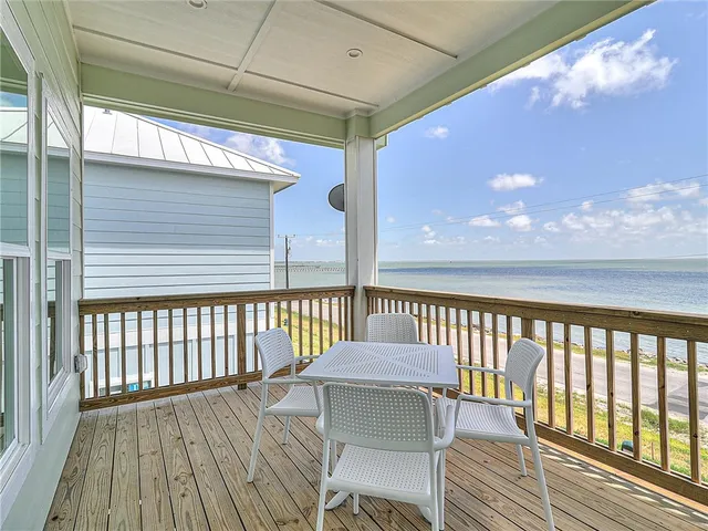 a view of a balcony with wooden floor