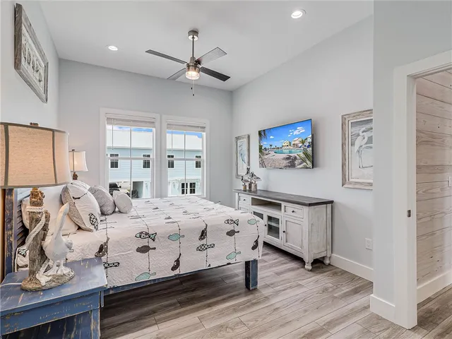 a bedroom with a large bed and a chandelier