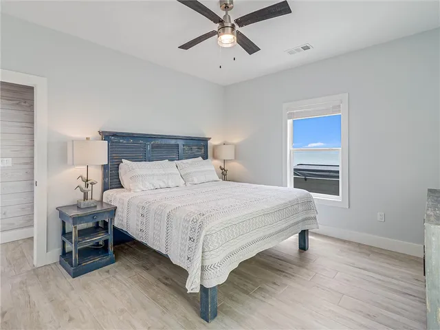 a bedroom with a bed and a ceiling fan