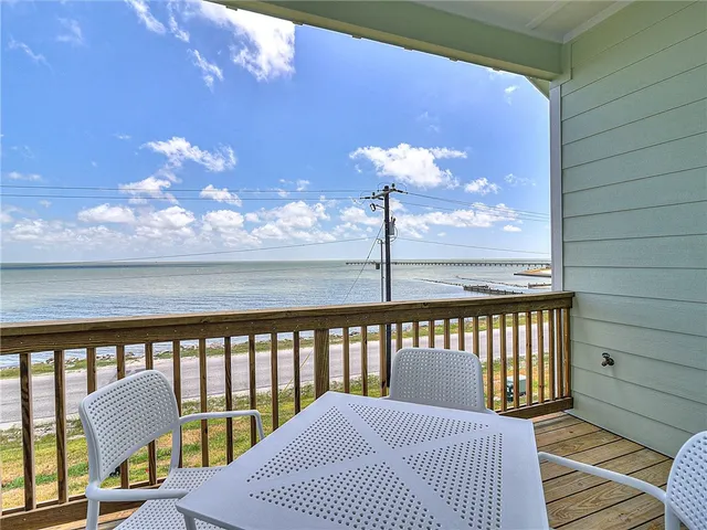 a view of a balcony with wooden chairs